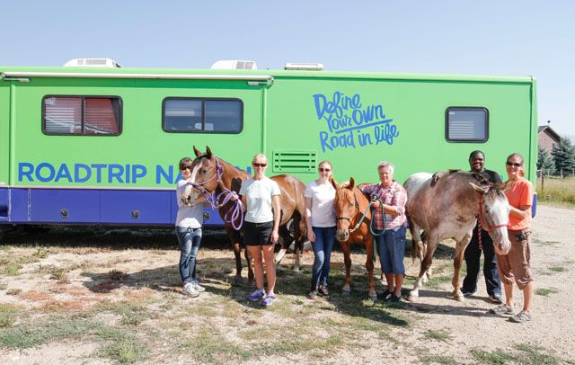 On the road in the green RV.